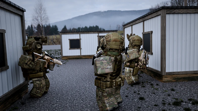 Special forces operators moving through a grey urban training site